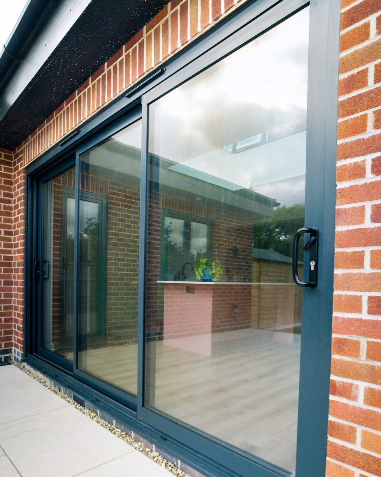 Anthracite aluminium sliding doors by JWA Building Services